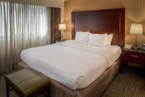 a hotel room with a large bed and a telephone at Crowne Plaza Hotel St. Louis Airport, an IHG Hotel in Bridgeton