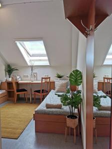 a room with two beds and a dining room with skylights at Híd Ifjúsági Szálló in Dunaújváros