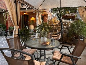 a patio with a table and chairs and an umbrella at Terrace Tbilisi Center in Tbilisi City