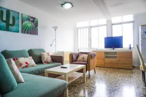 ein Wohnzimmer mit Sofa und Fernseher in der Unterkunft Caletillas Sun & Sea in Araya