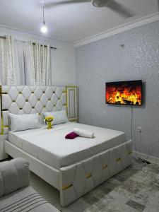 a bedroom with a large bed with a fireplace on the wall at Chillhaushomes in Mombasa