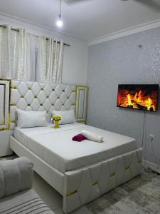 a bedroom with a large bed and a fireplace at Chillhaushomes in Mombasa
