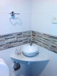 a bathroom with a white sink and a mirror at Buena Vista in Salto