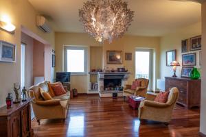 soggiorno con sedie e lampadario pendente di Assisi Relax, appartamento con 3 camere matrimoniali ad Assisi