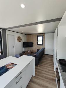 ein Wohnzimmer mit einem Sofa und einem Tisch in der Unterkunft Cottage Nature Piscine partagée Vue Vilaine in Arzal