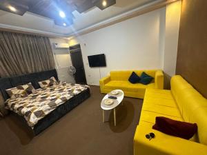 a living room with a bed and a couch at Furnished Studio for rent in Irbid