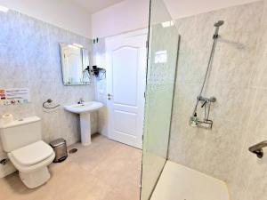 a bathroom with a shower and a toilet and a sink at Cozy House Casa de los Abuelos in Icod de los Vinos by in Icod de los Vinos +57 photos