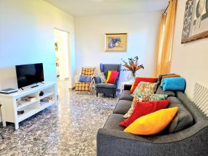 a living room with a couch and a tv at Cozy House Casa de los Abuelos in Icod de los Vinos by in Icod de los Vinos