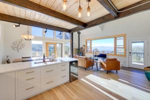 a kitchen with white cabinets and a living room at Luxury Haven with Hot Tub and Staunton State Park View in Conifer