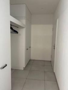 an empty room with white walls and white tile floors at Traumhafte Wohnung am Bodensee in Staad