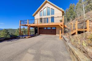 a house on a hill with a driveway at Luxury Haven with Hot Tub and Staunton State Park View in Conifer