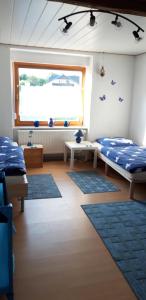 a room with two beds and a window at Ferienwohnung Obhausen bei Querfurt in Obhausen