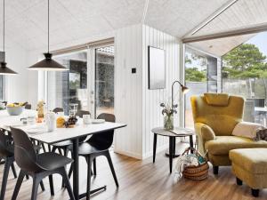 a kitchen and living room with a table and chairs at Luxury Villa with Pool - By Traum Ferienwohnungen in Kongsmark