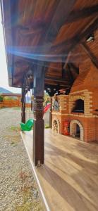 a building with a clock tower and a playground at Pensiunea Suci in Botiza
