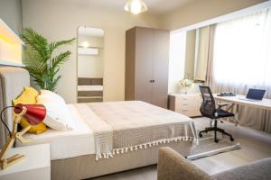 a bedroom with a bed and a desk with a computer at Downtown Oasis - Spacious Modern 3-BR Flat near Beachpark in Antalya