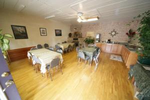 a room with tables and chairs and a kitchen at Rainbow Lodge and Inn in Colorado Springs