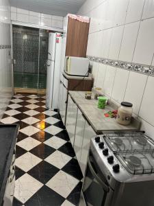 a kitchen with a stove and a checkered floor at Casa in Itu