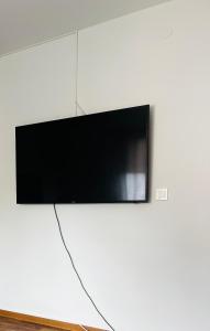 a flat screen tv hanging on a white wall at Golden joy in Sarajevo