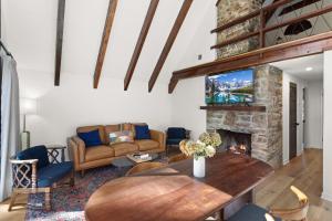 a living room with a table and a fireplace at A-Frame on Balsam in Valle Crucis