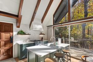 a kitchen with a large window and a kitchen island at A-Frame on Balsam in Valle Crucis