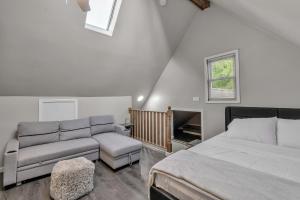 a bedroom with a bed and a couch at The Davey Retreat in Buffalo