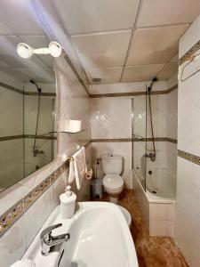 a bathroom with a sink and a toilet and a shower at APARTAMENTO SANMIGUEL CENTRO in Córdoba +10 photos