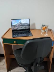 a desk with a laptop computer on top of it at Guatemala, departamento ciudad capital zona 12. in Guatemala