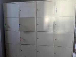 a row of white lockers in a room at 4 Couples & 4 Friends Hostel in Kraków