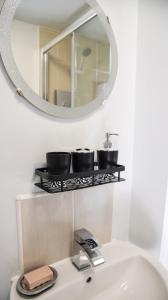 a bathroom with a sink and a mirror on the wall at 3 Bedroom House close to city centre in Liverpool