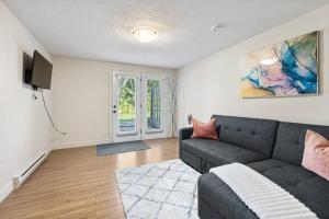 a living room with a couch and a tv at Quite 1 bedroom apartment. in Dieppe