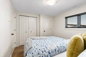 a white bedroom with a bed and a window at Quite 1 bedroom apartment. in Dieppe