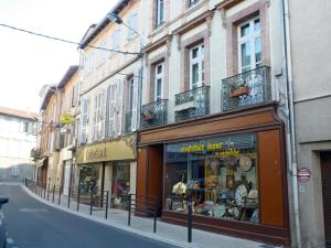 een straat met een winkel aan de zijkant van een gebouw bij Au Nid de la Madeleine in Gaillac