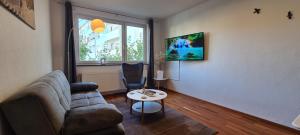 a living room with a couch and a chair at City Wohnung 3 Zimmer in Bremen