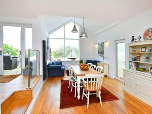 a kitchen and living room with a table and chairs at Water Edge in Dittisham