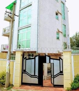 ein großes Gebäude mit einem schwarzen und weißen Tor in der Unterkunft Keba Guest House in Addis Abeba