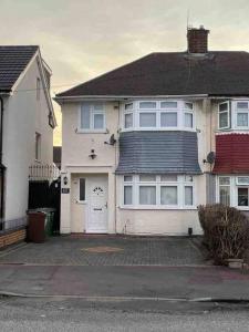 a large white house with a driveway in front of it at Modern 3 Bed House in Dagenham