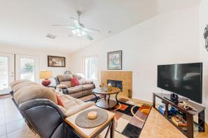 a living room with a couch and a flat screen tv at Golf Paradise at Mission Lakes in Desert Hot Springs