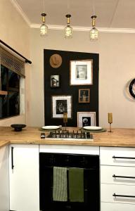 a kitchen with a black and white stove top oven at Industrial farm stay in Polokwane in Eerstegoud