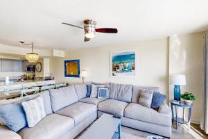a living room with a couch and a kitchen at Beachwalk Villas 504 in Myrtle Beach