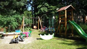 a playground with a slide and a swing set at Dom Natury in Karpacz