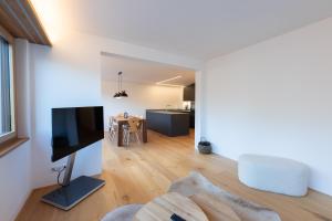 a living room with a flat screen tv and a couch at New! Exclusive Apartment 3min to Chantarella Bahn in St. Moritz