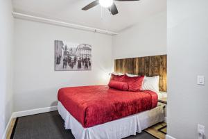 a bedroom with a bed with a red blanket at Stylish Virginia City Apartment with Deck! in Virginia City