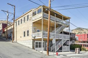 a wooden building with stairs on the side of it at Stylish Virginia City Apartment with Deck! in Virginia City