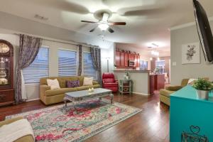 a living room with a couch and a table at Patio, Pergola and Pool Access Aubrey Retreat! in Corinth
