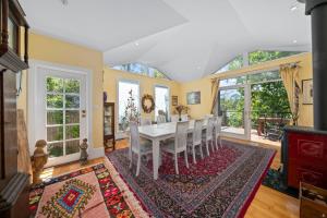 a dining room with a white table and chairs at Berdea in Leura