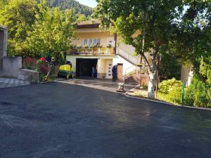 a house with a garage with a car on a driveway at Azra in Visoko