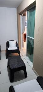 a room with a couch and a chair and a window at You deserve a comfortable stay! in Santiago de los Caballeros