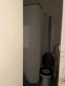 baño con aseo y asiento negro en Bastille Cosy Flat Paris, en París