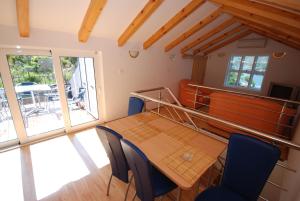 a dining room with a table and chairs at Springs Apartments & Rooms in Sveti Stefan