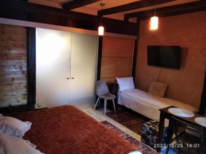 a hotel room with two beds and a tv at CASTEL RESIDENCE in Braşov